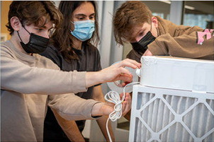two students preparing an air filter