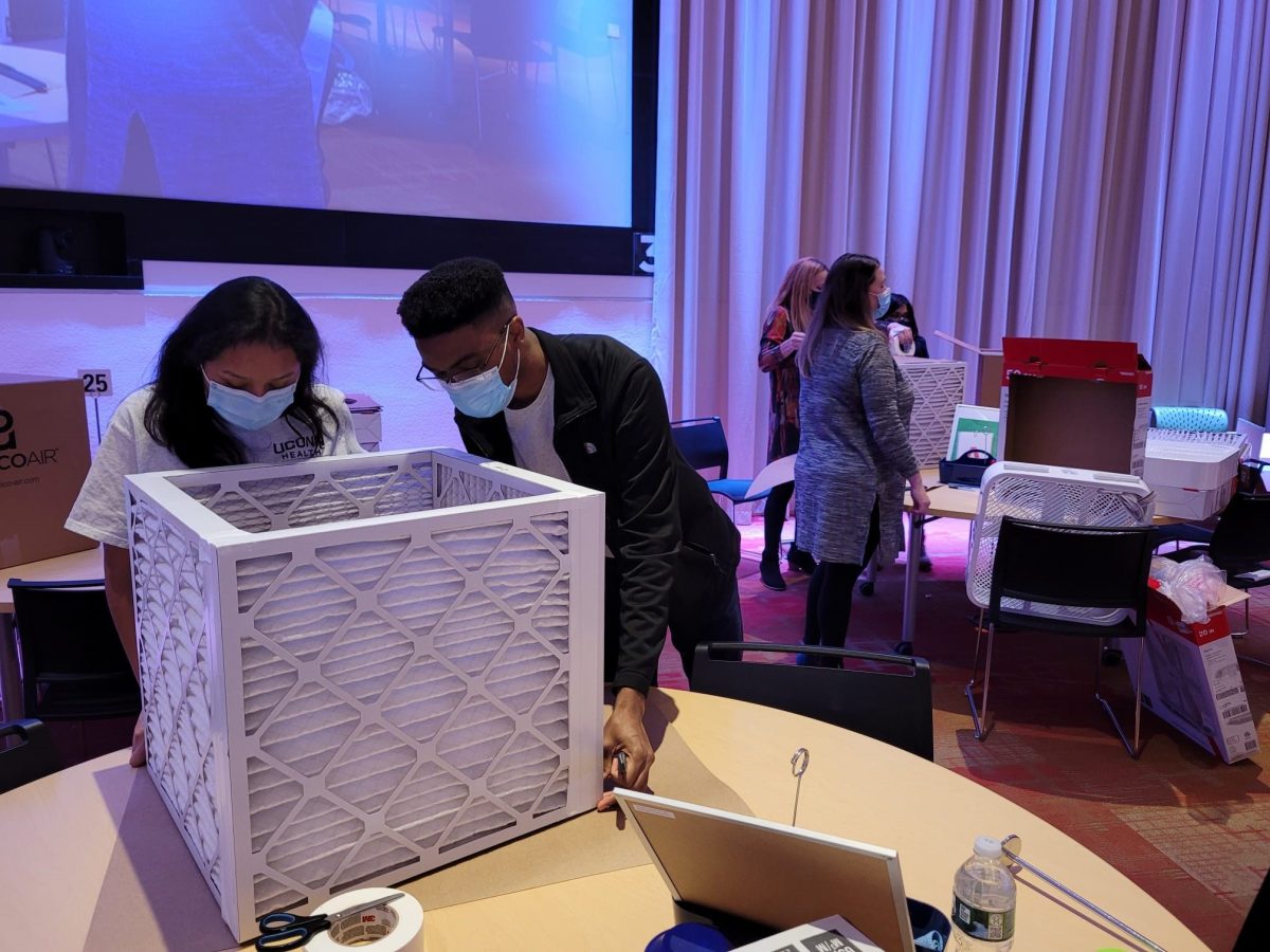 two people preparing an air purifier