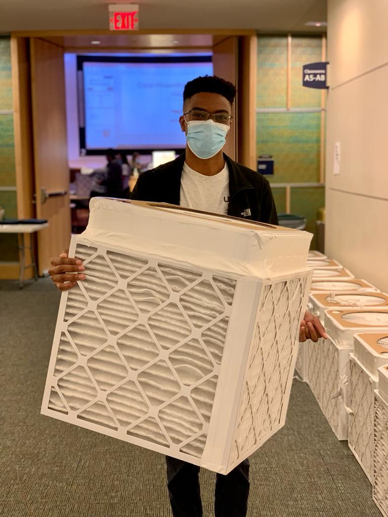 medicine-2021-12-04-3 male student carrying DIY air filter photo