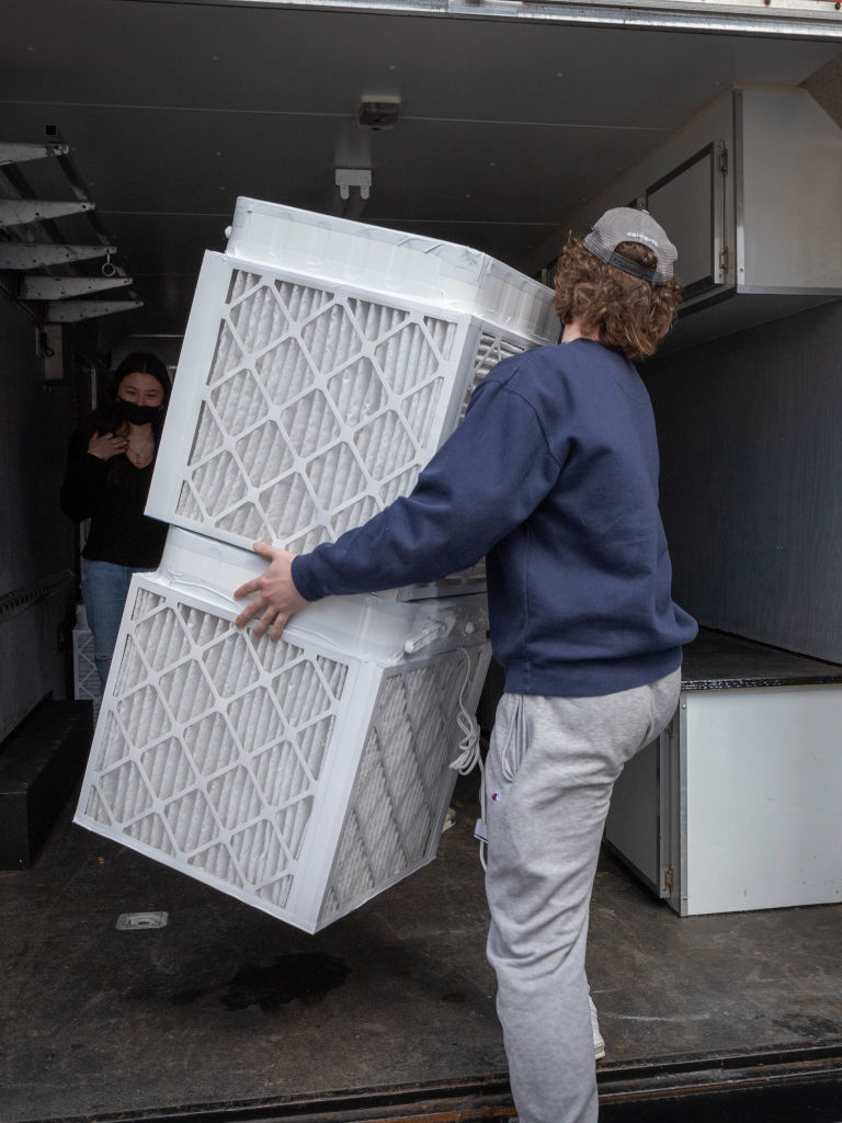 feb-2022-2 student putting air filters in truck