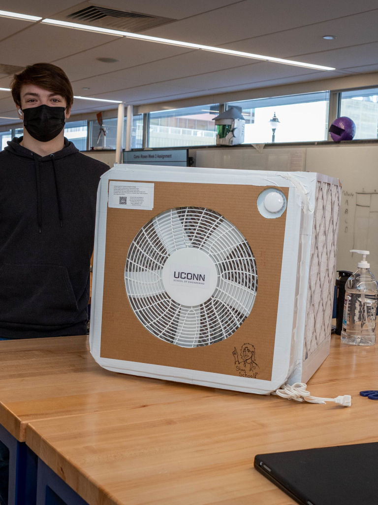 feb-2022-6 student standing aside air filter