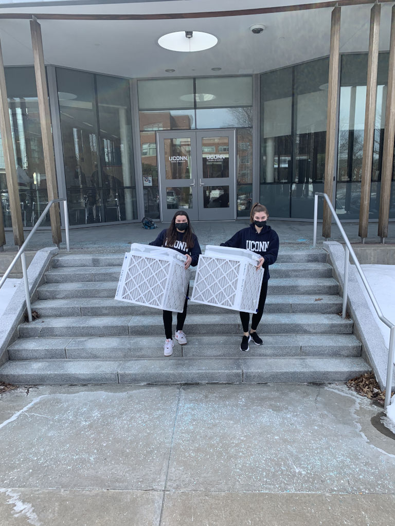 mar-2022-3 two students carrying air filters